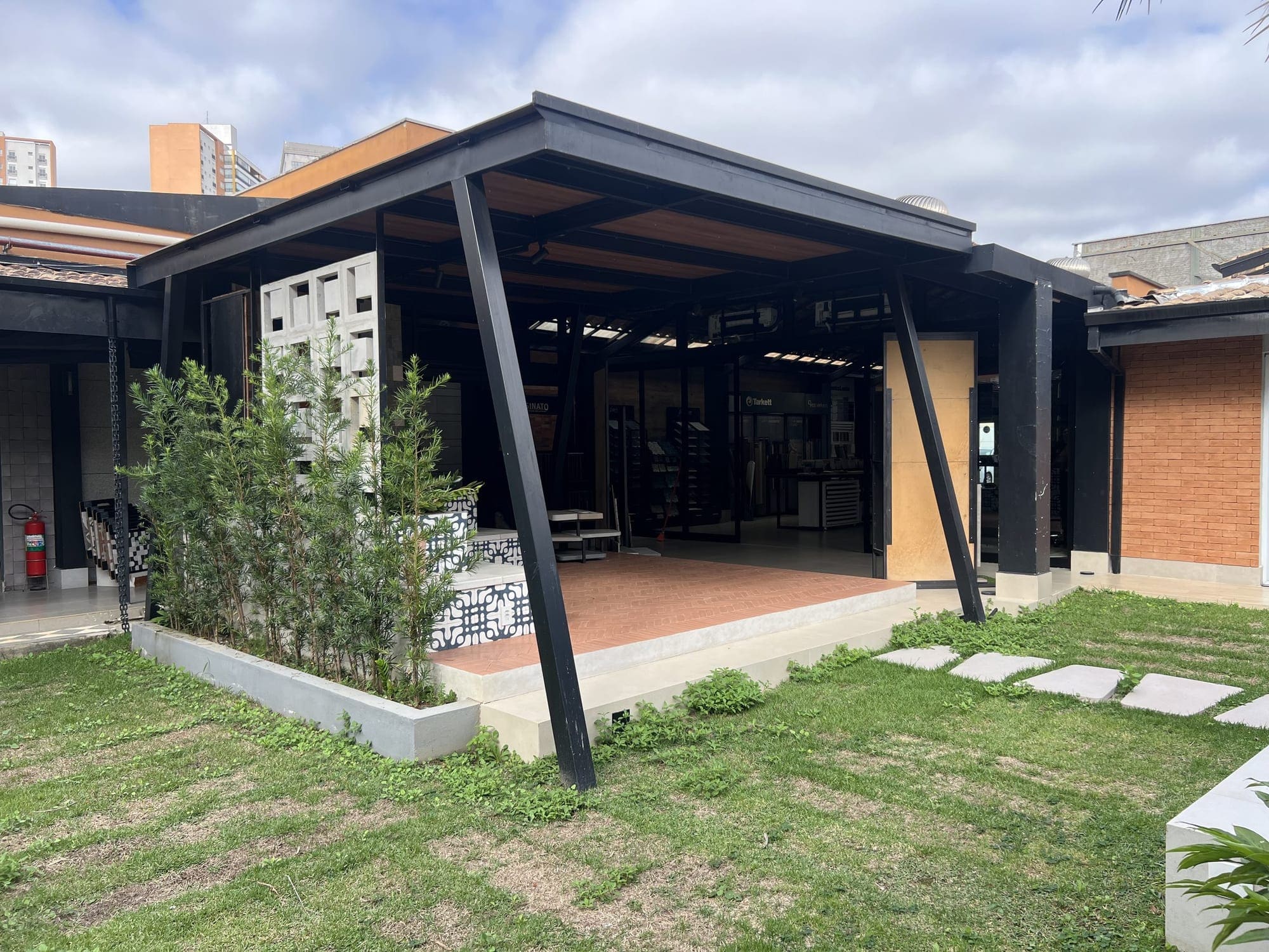Pergolado de estrutura metálica na área externa do showroom
